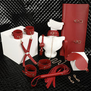 Wondebliss 7-piece bondage kit full set in red, including collar, cuffs, eye mask, mouth gag, whip and storage bag
