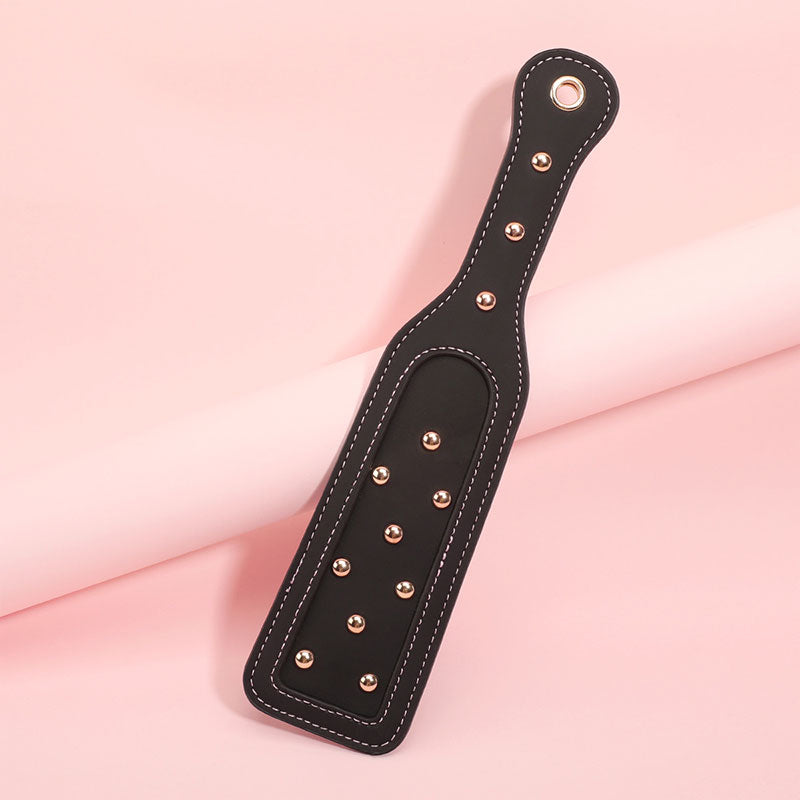 Wondebliss black spanker paddle with pink lace accent from bondage set