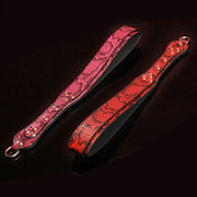 Wondebliss snake print spanking paddle in red and fuchsia, flat lay display