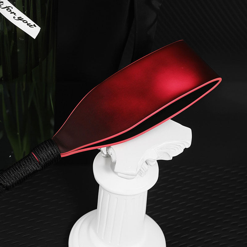 Wondebliss heat-sensitive leather spanker close-up showing faux leather texture and color change detail